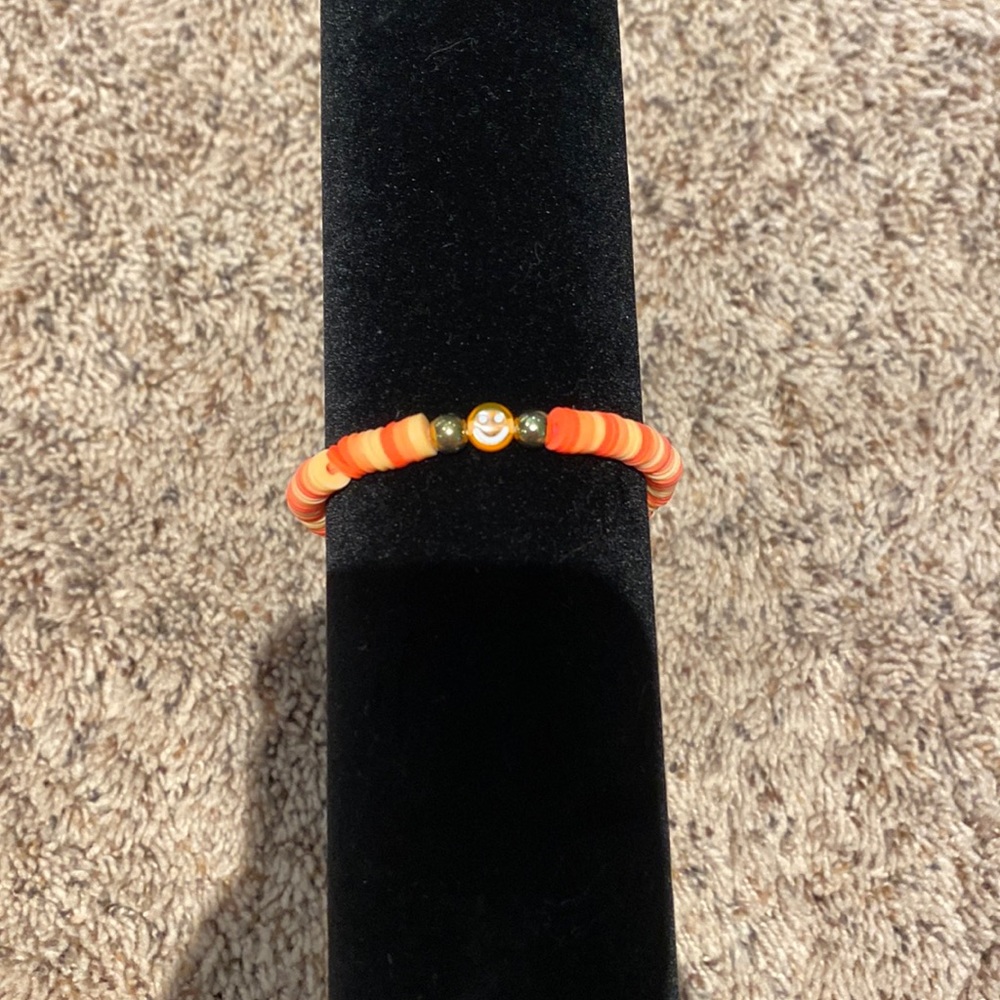 Clay bracelet with colors that are orange and light orange. Fits great hand made